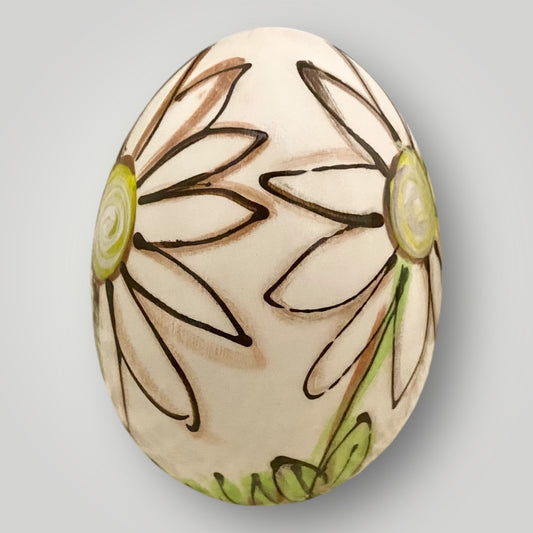 Egg‑shaped pottery piece with hand‑painted daisies artwork, handmade by Heartfelt Traditions Pottery