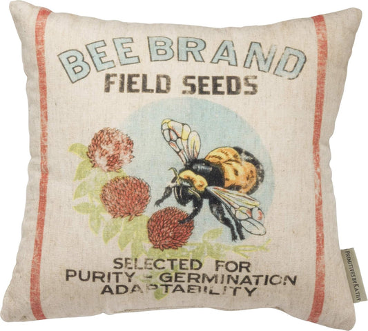 Decorative pillow with bee and field seeds design on a white background